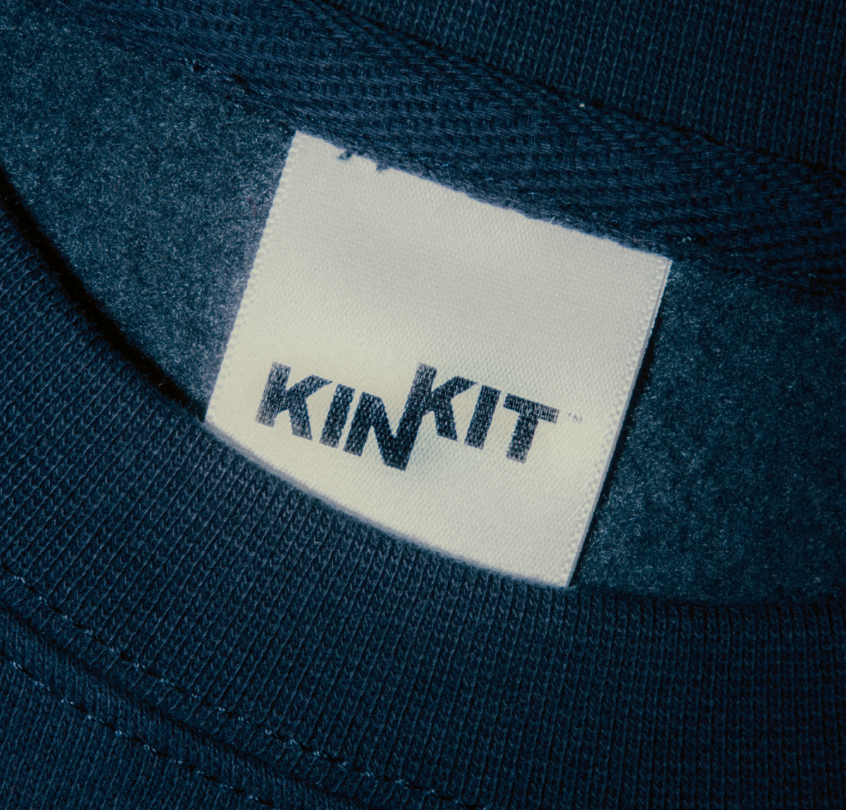 Close-up of a KIN KIT woven label